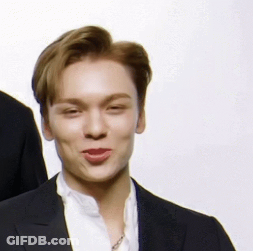A Close Up Of A Man Wearing A Suit And A White Shirt Making A Funny Face . GIF