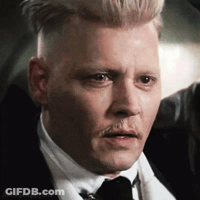 A Close Up Of A Man Wearing A Suit And Tie With A Mustache . GIF
