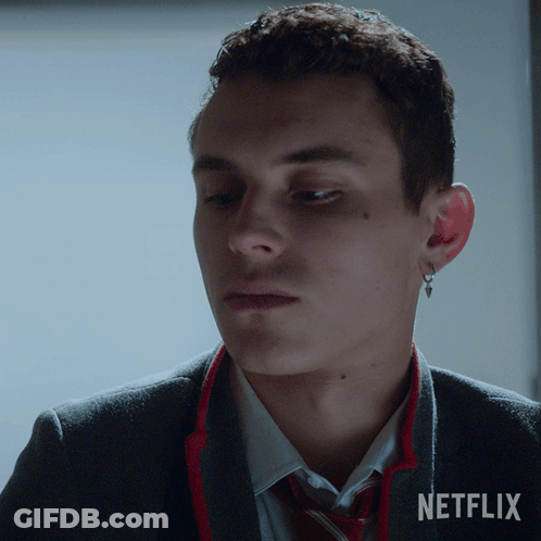 A Close Up Of A Man Wearing A Suit And Tie With Netflix Written On The Bottom GIF