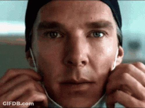 A Close Up Of A Man Wearing A Surgical Mask . GIF