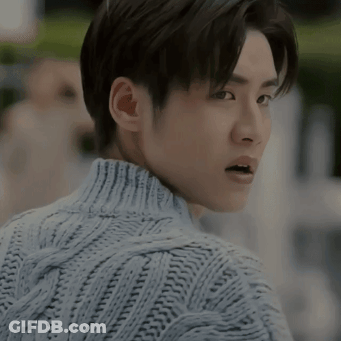A Close Up Of A Man Wearing A Sweater With His Mouth Open GIF