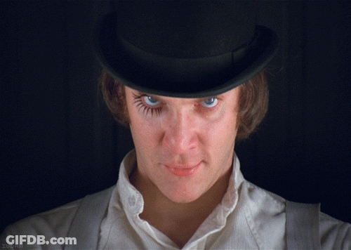 A Close Up Of A Man Wearing A Top Hat And A White Shirt GIF