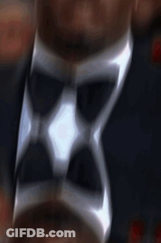 A Close Up Of A Man Wearing A Tuxedo With A Bow Tie GIF