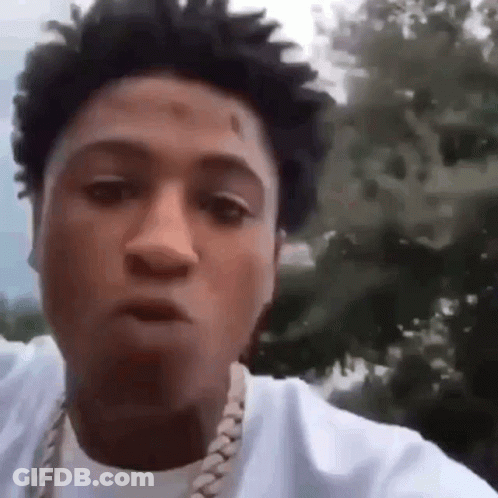 A Close Up Of A Man Wearing A White Shirt And A Gold Chain . GIF