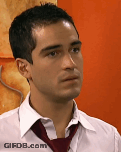 A Close Up Of A Man Wearing A White Shirt And Red Tie GIF