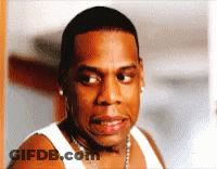 A Close Up Of A Man Wearing A White Tank Top And A Chain Around His Neck GIF