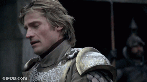 A Close Up Of A Man Wearing Armor With A Dragon On The Shoulder GIF