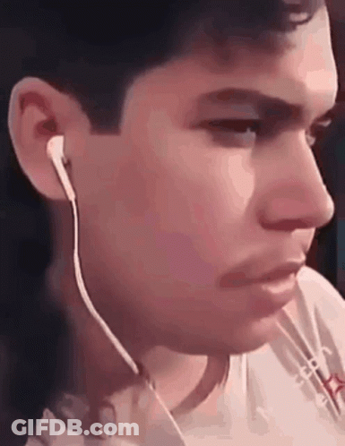 A Close Up Of A Man Wearing Ear Buds GIF