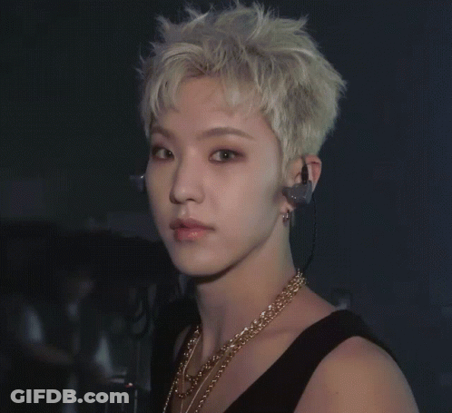 A Close Up Of A Man Wearing Earphones And A Gold Necklace GIF