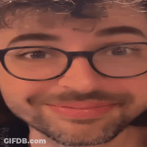A Close Up Of A Man Wearing Glasses And A Beard With His Eyes Closed GIF