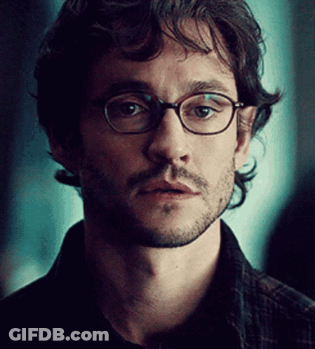 A Close Up Of A Man Wearing Glasses And A Beard GIF