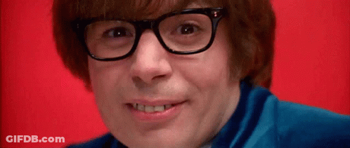 A Close Up Of A Man Wearing Glasses And A Blue Shirt On A Red Background . GIF