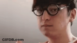 A Close Up Of A Man Wearing Glasses And A Hat Making A Funny Face . GIF