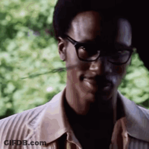 A Close Up Of A Man Wearing Glasses And A Jacket . GIF