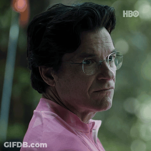 A Close Up Of A Man Wearing Glasses And A Pink Shirt With The Hbo Logo In The Corner GIF