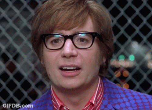 A Close Up Of A Man Wearing Glasses And A Polka Dot Shirt GIF