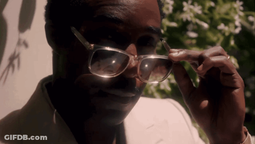 A Close Up Of A Man Wearing Glasses And A Ring GIF