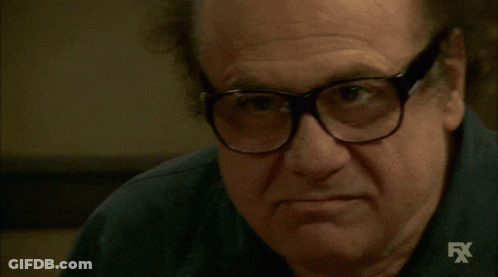 A Close Up Of A Man Wearing Glasses And A Shirt With Fx Written On It GIF