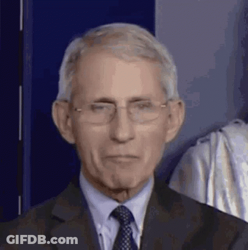 A Close Up Of A Man Wearing Glasses And A Suit . GIF