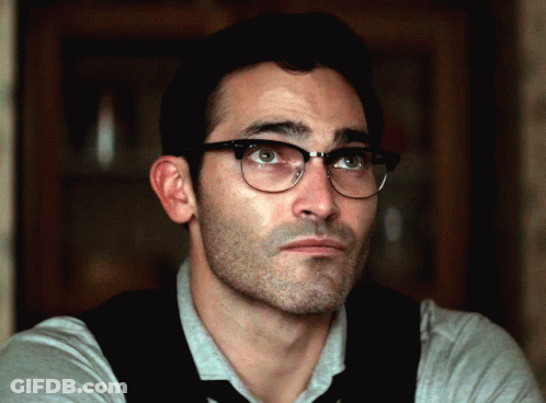 A Close Up Of A Man Wearing Glasses And A Tie GIF