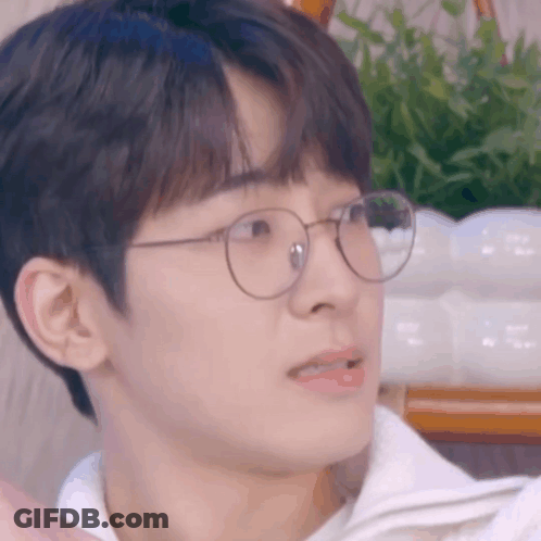 A Close Up Of A Man Wearing Glasses And A White Shirt . GIF