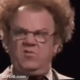 A Close Up Of A Man Wearing Glasses And A Wig . GIF