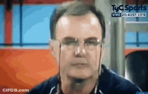 A Close Up Of A Man Wearing Glasses And Headphones On A Television Screen . GIF