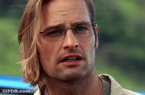 A Close Up Of A Man Wearing Glasses And Long Hair GIF