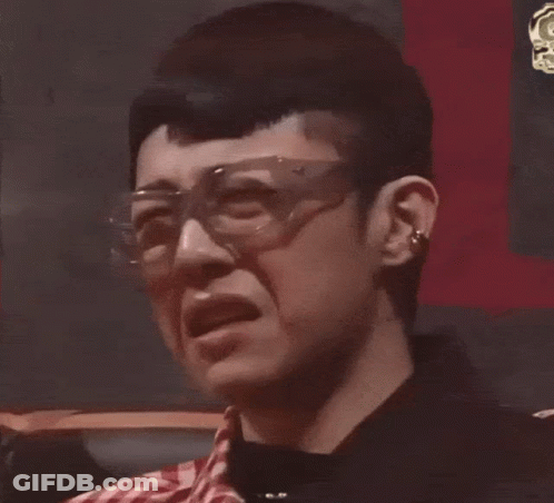 A Close Up Of A Man Wearing Glasses And Making A Funny Face GIF