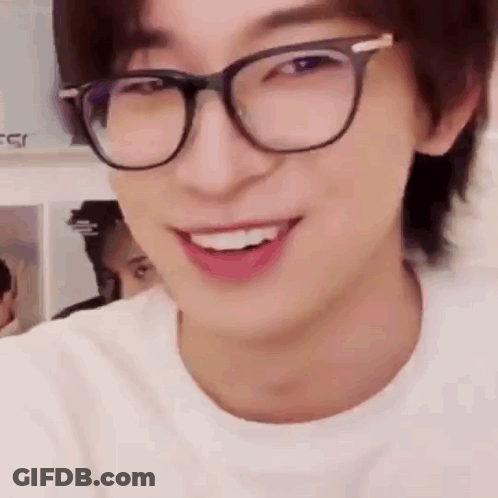 A Close Up Of A Man Wearing Glasses And Smiling . GIF