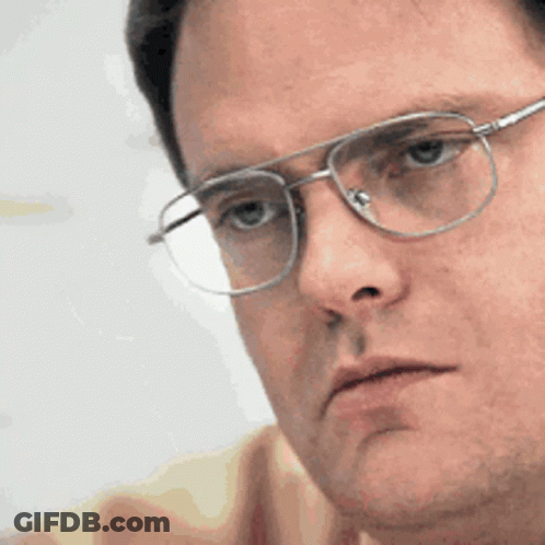 A Close Up Of A Man Wearing Glasses Looking At Something GIF