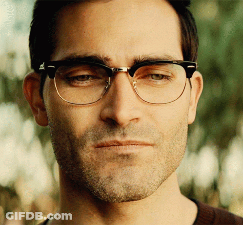 A Close Up Of A Man Wearing Glasses Looking At The Camera GIF
