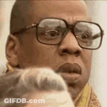 A Close Up Of A Man Wearing Glasses Making A Face . GIF