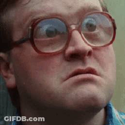 A Close Up Of A Man Wearing Glasses Making A Face . GIF
