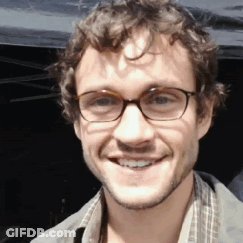 A Close Up Of A Man Wearing Glasses Smiling GIF