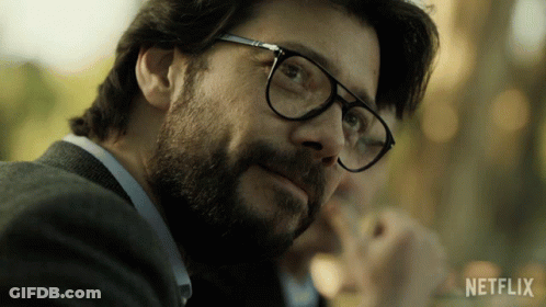 A Close Up Of A Man Wearing Glasses With A Netflix Logo In The Background GIF