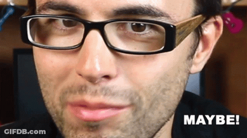 A Close Up Of A Man Wearing Glasses With The Word Maybe On The Bottom Right GIF