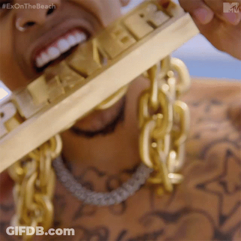 A Close Up Of A Man Wearing Gold Chains And A Gold Bar That Says Exon The Beach GIF