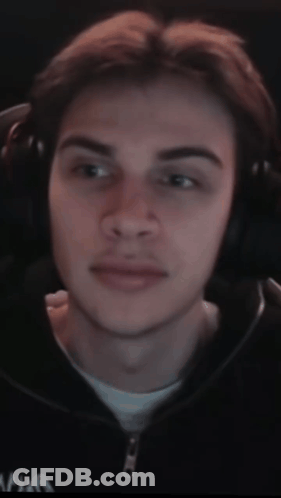 A Close Up Of A Man Wearing Headphones And A Black Jacket With The Letter A On It GIF