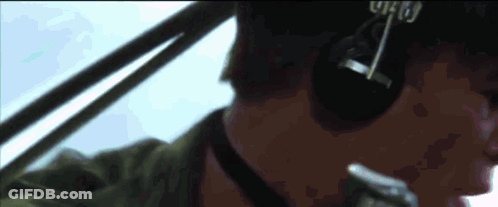 A Close Up Of A Man Wearing Headphones And A Hat With The Word Who On It GIF