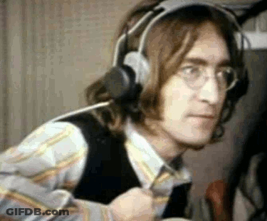 A Close Up Of A Man Wearing Headphones And Glasses In A Room . GIF