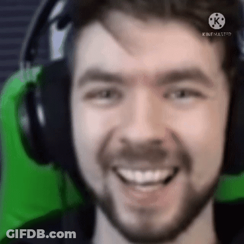 A Close Up Of A Man Wearing Headphones And Smiling GIF