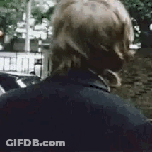 A Close Up Of A Man Wearing Headphones Standing On A Street . GIF