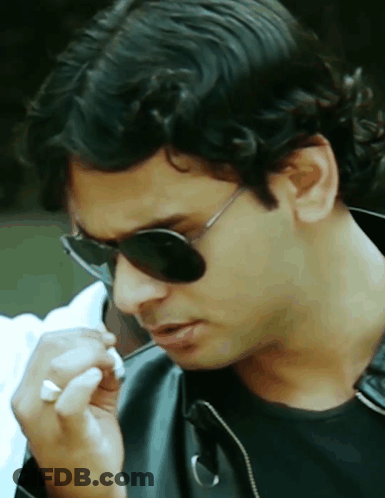 A Close Up Of A Man Wearing Sunglasses And A Black Jacket GIF