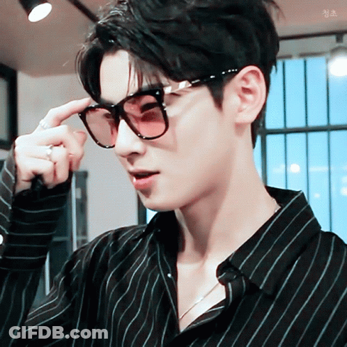 A Close Up Of A Man Wearing Sunglasses And A Black Shirt GIF