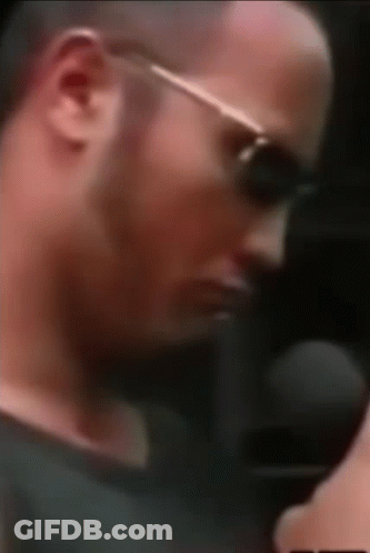 A Close Up Of A Man Wearing Sunglasses And A Microphone . GIF