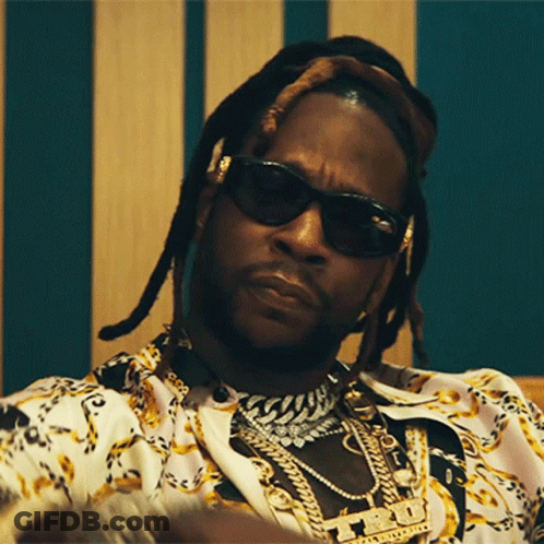 A Close Up Of A Man Wearing Sunglasses And A Necklace With A Pendant That Says ' T.i. ' GIF