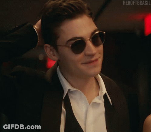 A Close Up Of A Man Wearing Sunglasses And A Suit And Tie . GIF