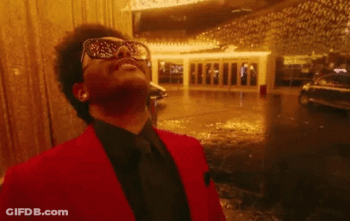 A Close Up Of A Man Wearing Sunglasses And Laughing With His Mouth Open . GIF