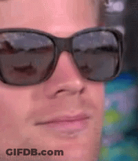 A Close Up Of A Man Wearing Sunglasses And Making A Funny Face GIF
